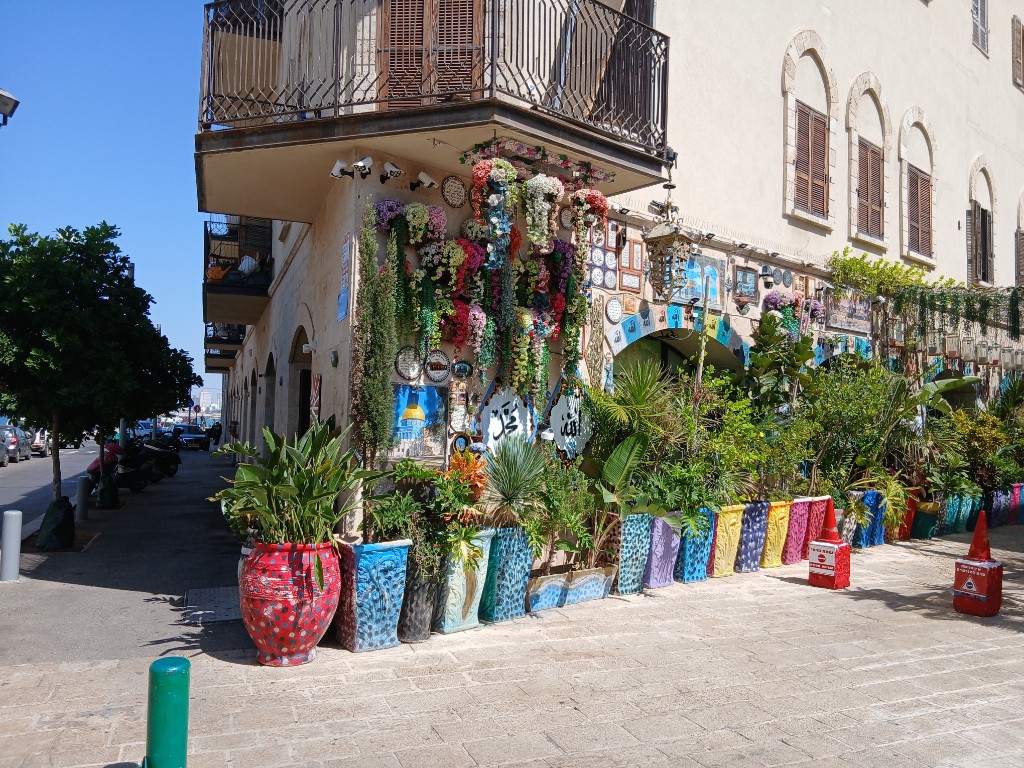 A corner full of flowers and painted pots